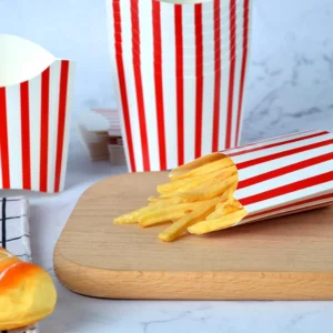 Gallery image of Custom French Fries boxes - A wooden board showcasing a red-and-white striped container filled with golden fries, with additional empty containers in the background.